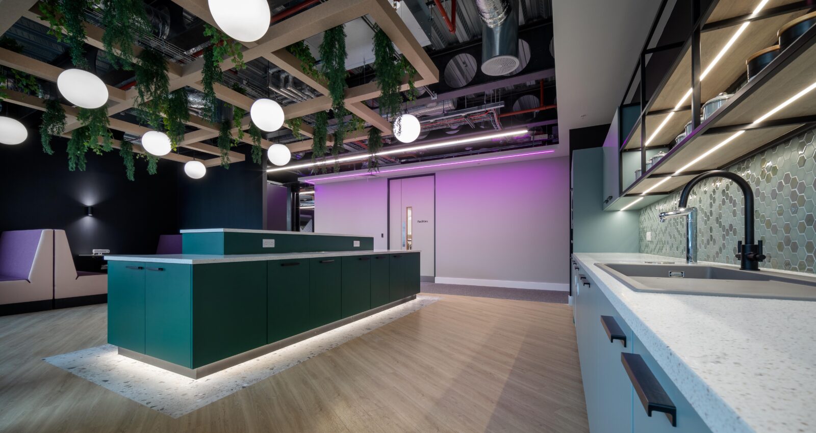 Modern office kitchen with purple lighting