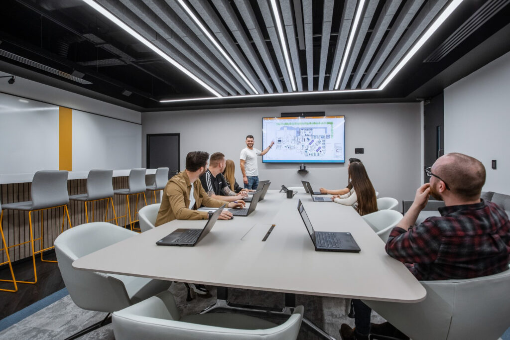 Man delivering a presentation in an office boardroom. 