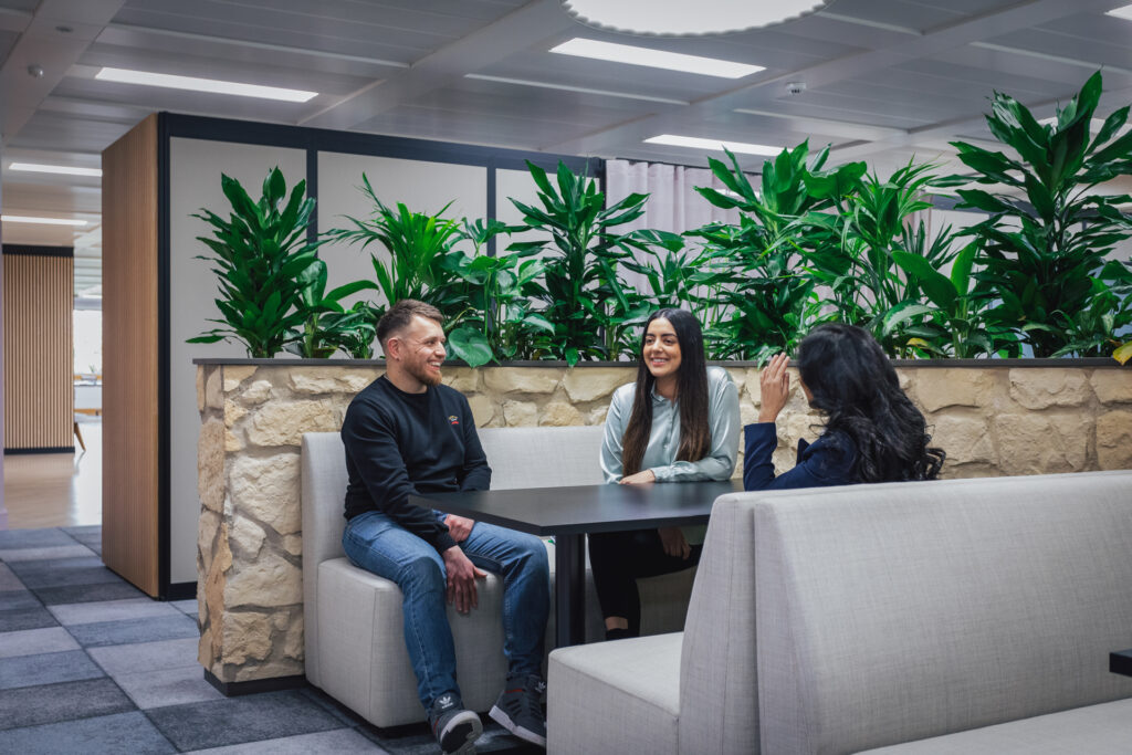 Group of workers laughing at table.